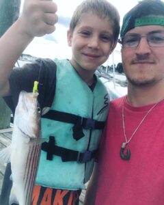 Little man and little striper #striperfishing #spring #takeakidfishing #tillerli…