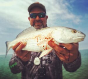 with a bloody Everglades redfish. Later when we looked at a picture in the mirr