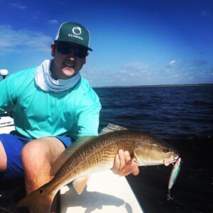 Graham with a beautiful top water redfish he caught yesterday on the Taylor Coun