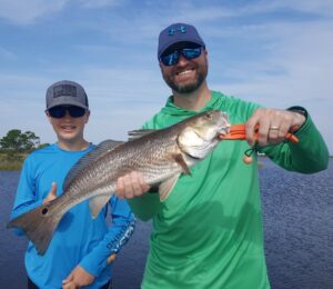 Mark and son Cooper visiting from Georgia show off a decent Redfish from yesterd